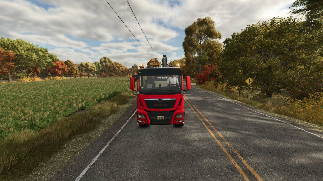 Red MAN TGS 18500 truck on a country road in FS25 mod, showcasing autumn scenery with trees and fields.