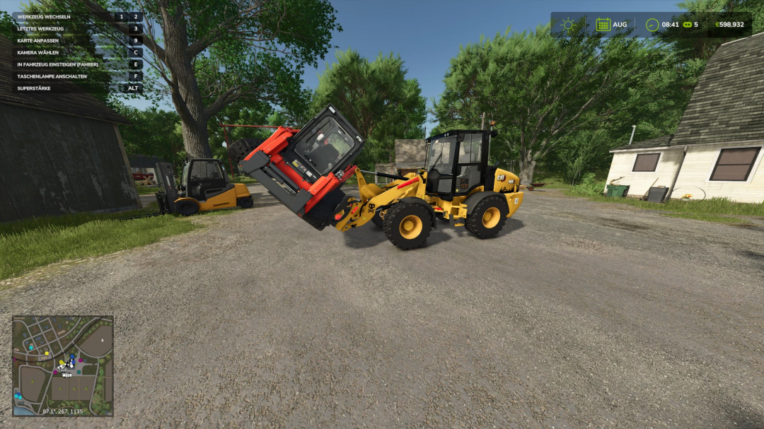 FS25 mod: yellow CAT loader using pallet fork with tension straps lifting equipment. Trees and buildings in the background.