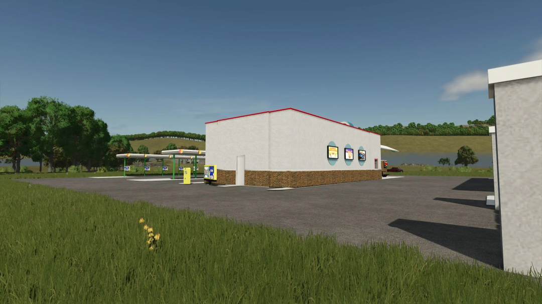 FS25 mods Sonic v1.0.0.0 showing a rural gas station and store surrounded by trees and fields.