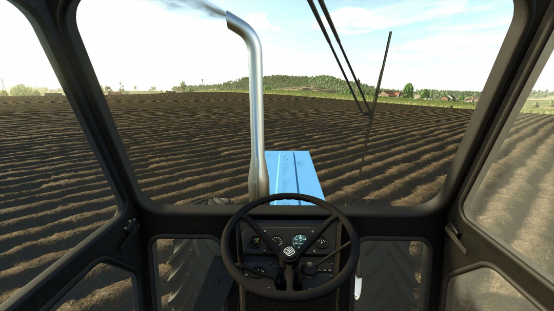 FS25 mod: View from inside Universal 1010DT tractor cab over a plowed field.