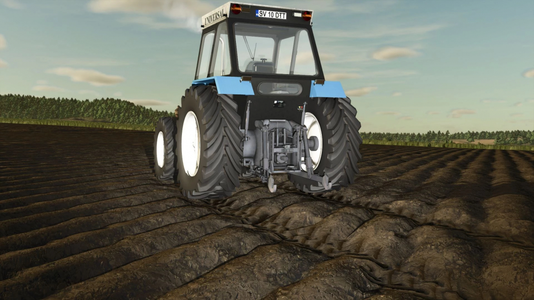 Universal 1010DT tractor mod in FS25 driving across a plowed field.