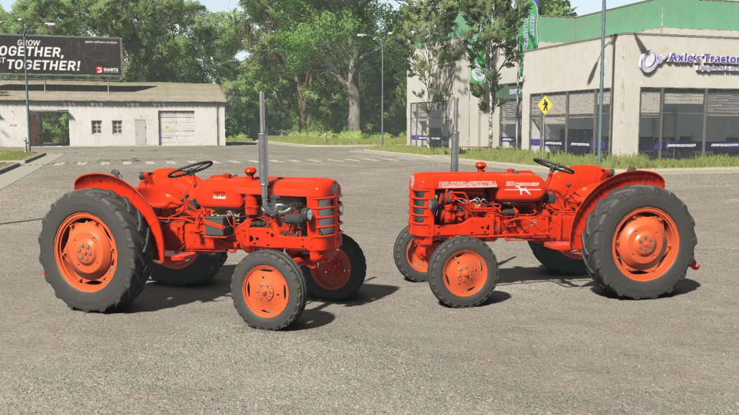 Two vintage red Volvo tractors in FS25 mod Volvo T425 v1.0.0.0 parked outside tractor shop.