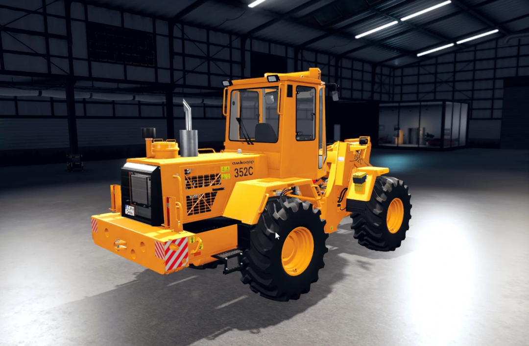 Amkodor 352C v1.0.0.1 loader mod in FS25, showcased in a garage setting.