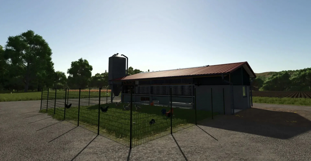 BigChickenBarn mod in FS25 with fenced grassy area and silo.