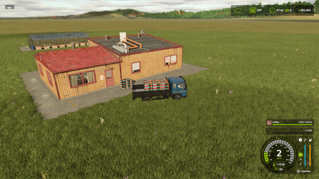 FS25 mod Coffee Production building with a truck loaded with coffee crates on a grassy field.