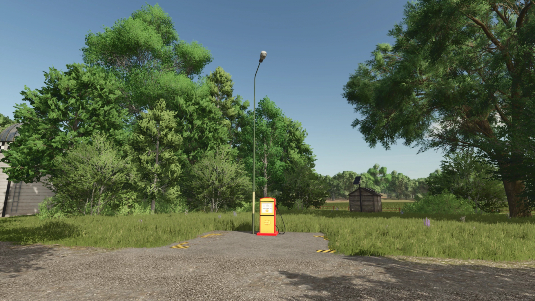 Diesel pump in a lush green field, part of FS25 mods Diesel Production small v1.0.0.0.