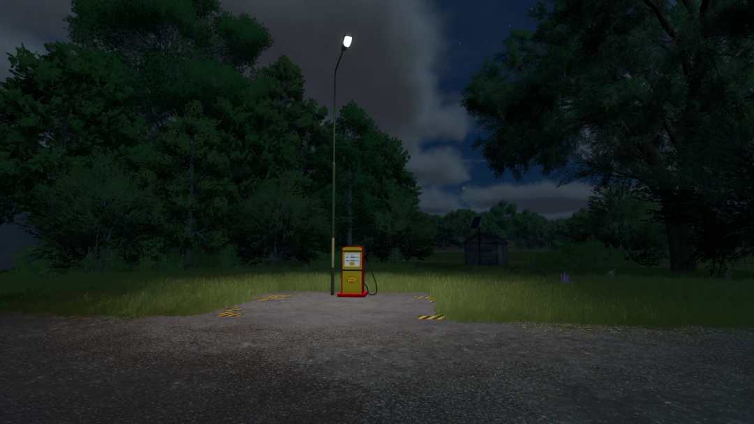 Night scene of small diesel production mod in FS25, showing a fuel pump under a streetlight amidst trees.