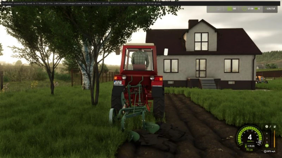 FS25 W?ademirec T25 mod in Farming Simulator 25, plowing field near a house, showcasing tractor gameplay.