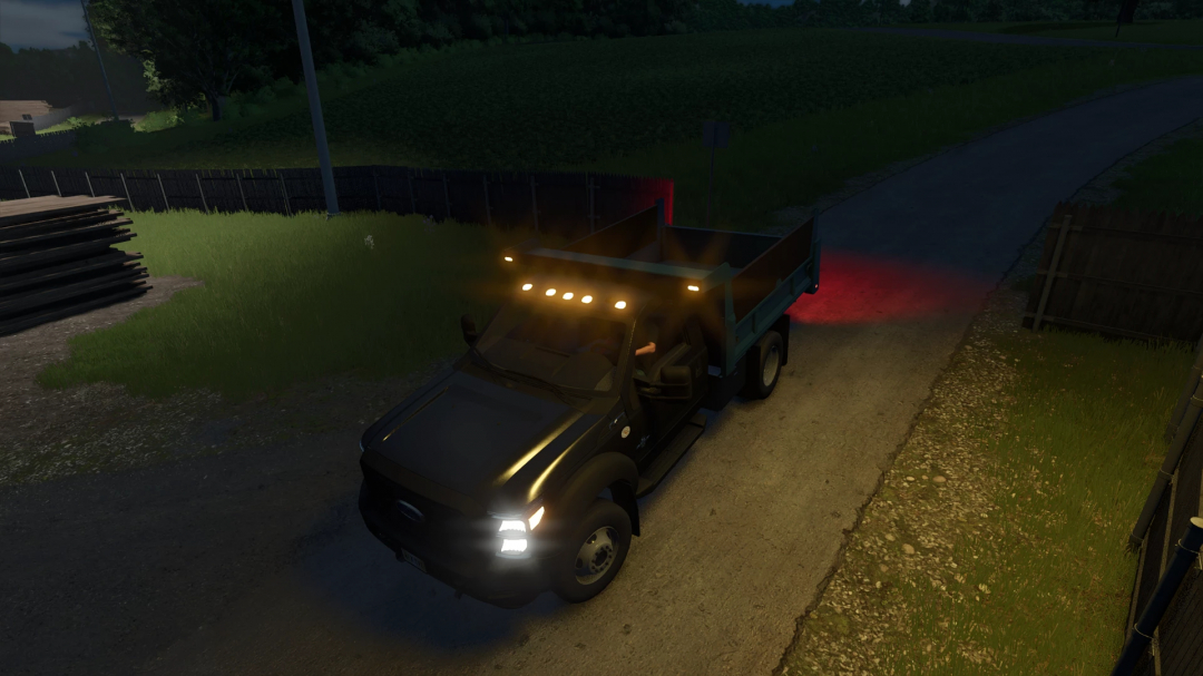 Ford F550 Dump Truck mod in FS25, illuminated by headlights, parked on a rural road at night.