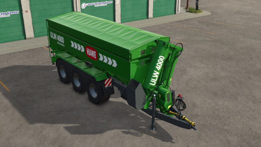 FS25 mod Hawe ULW 4000 trailer in green parked at a building.