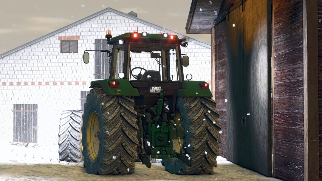 Rear view of John Deere 4955 tractor mod in FS25, parked in snowy barnyard.