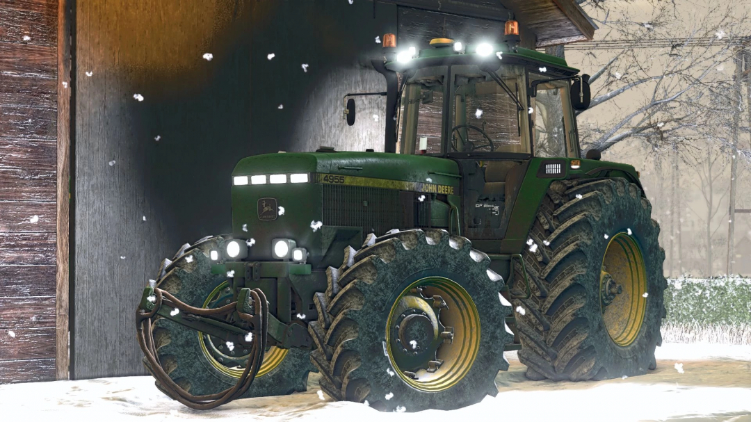 John Deere 4955 tractor with snow, featured in FS25 mods, parked by a barn.