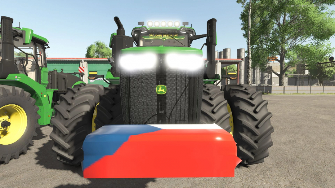 FS25 mod John Deere 9R/X Series tractor in focus, with headlights on, showcasing detailed front grill design.