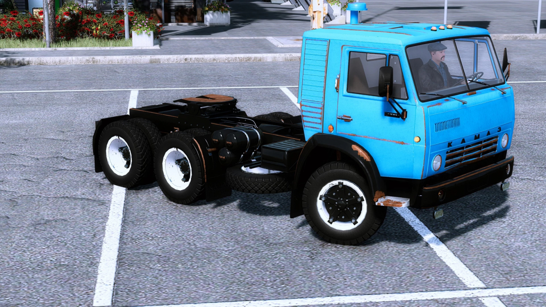 FS22 mod Kamaz 54112 semi v1.0.0.0 in a parking lot showcasing its blue cabin and black chassis.