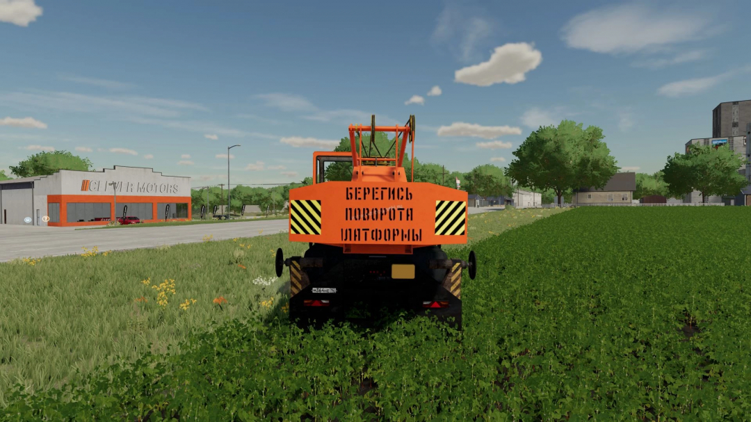 FS22 mod KrAZ 250 KS4561 crane in a field near a building, showcasing detailed vehicle design in Farming Simulator 22.