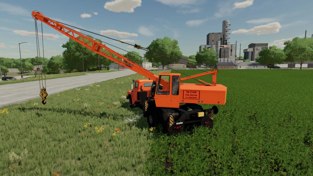 FS22 mod KrAZ 250 KS4561 crane near a road and factory in Farming Simulator 22.