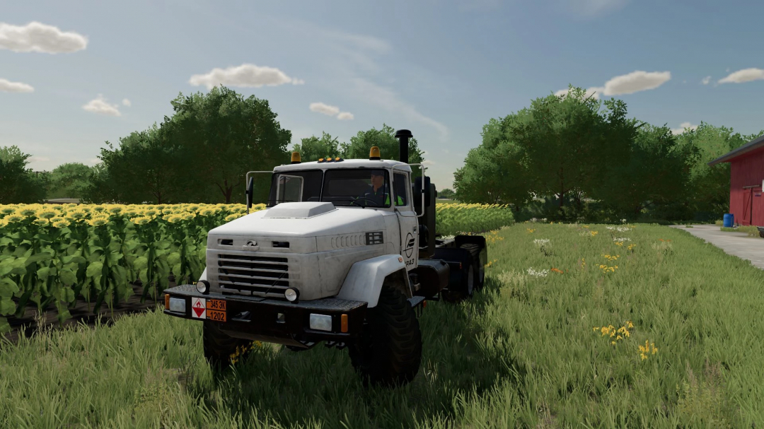 Kraz 6322 truck mod in FS22, parked in a field near sunflowers.