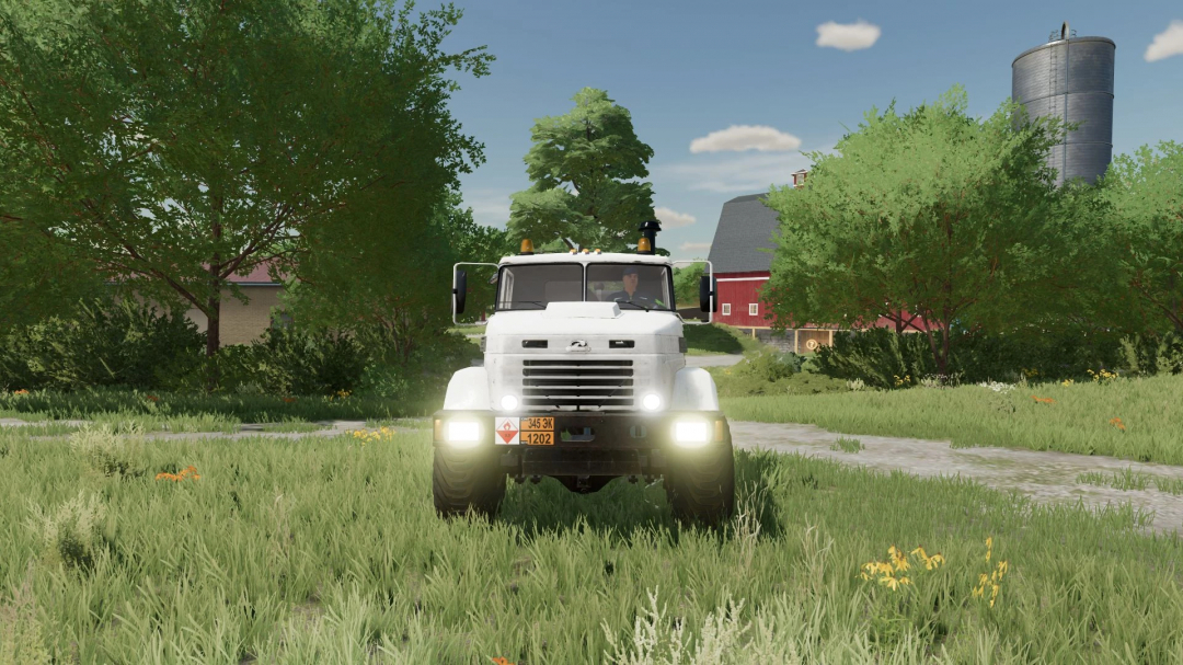 Kraz 6322 truck mod in FS22 on a farm path, surrounded by trees and a barn in the background.