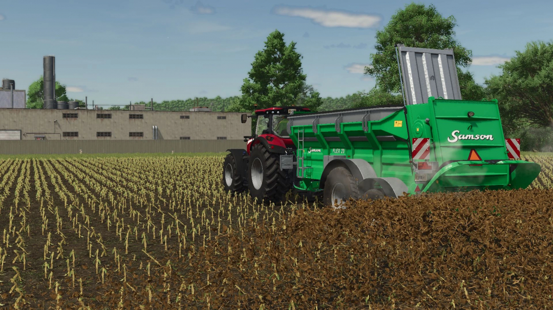 FS25 mod Samson Flex 23 v1.0.0.0 in action, spreading fertilizer on a field next to a factory.