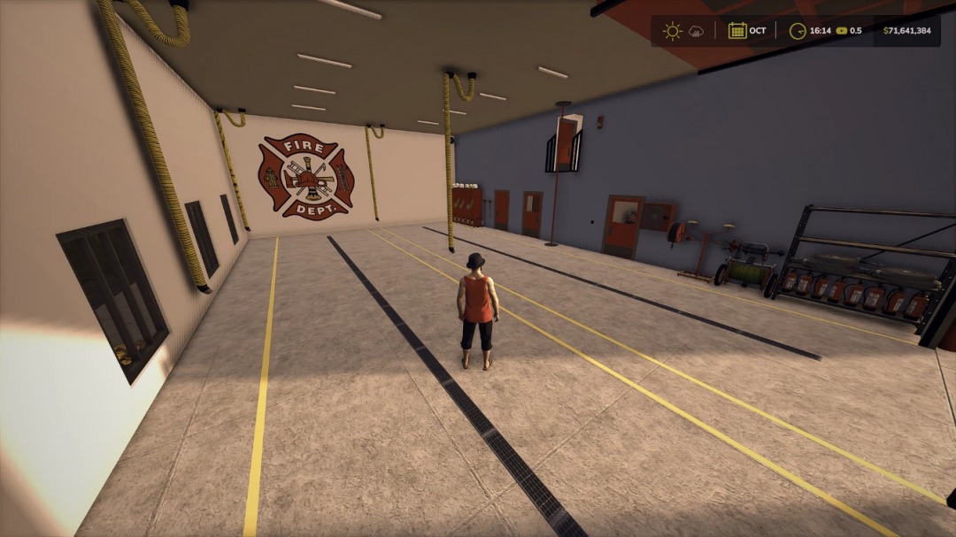 Interior view of FS25 Volunteer Fire Station mod featuring fire equipment and logo.