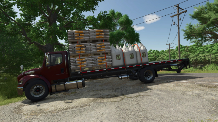 fs25-mods,  Freightliner M2 Stakebed AutoLoad mod in FS25, loaded with pallets and bags on a rural road.