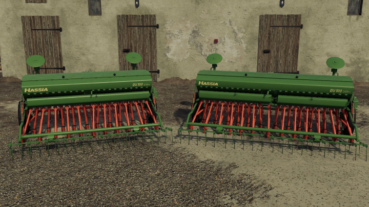 fs25-mods,  FS25 Hassia Pack v1.0.0.0 mod featuring green and red seed drills against a barn background in Farming Simulator 25.