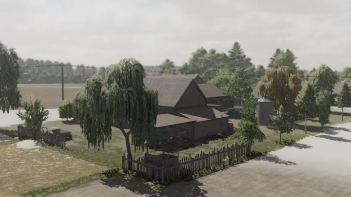 fs22-mods,  FS22 mod Savegame Szpakowo v1.0.0.1 depicts a rural farm landscape with trees, a barn, and fenced areas in Farming Simulator 22.