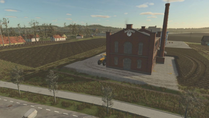 fs25-mods, FS25 Whiskey Factory mod showing a brick factory building in a rural landscape with fields and a tractor nearby.