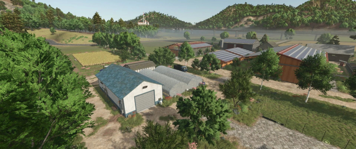 fs25-mods, Yurihonjo Map v1.0.1.0 showcases lush green farmland with various buildings and distant mountains in FS25.