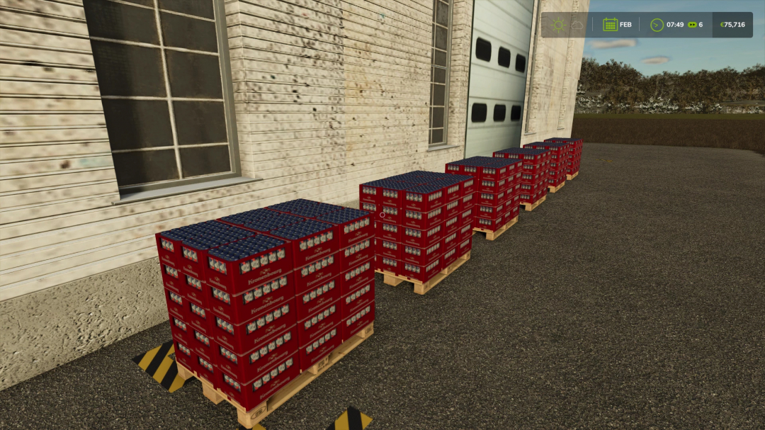 FS25 beer production mod showing red crates of beer on pallets outside a building.