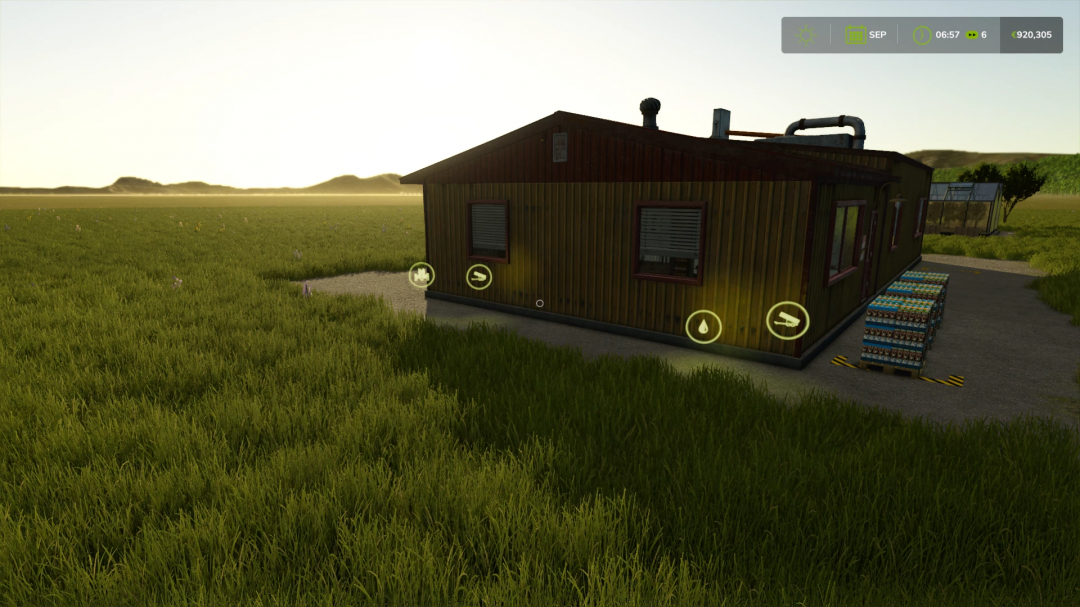 Coffee production building in FS25 mod with pallets outside, set in a grassy field.