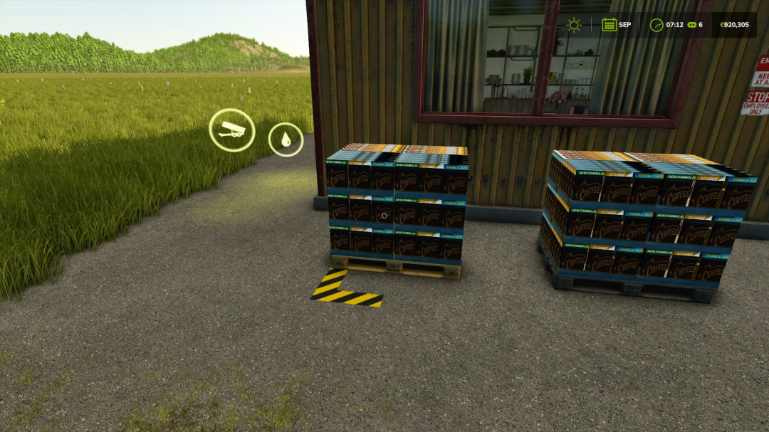 FS25 mods Coffee Production showing pallets of coffee outside a production building.