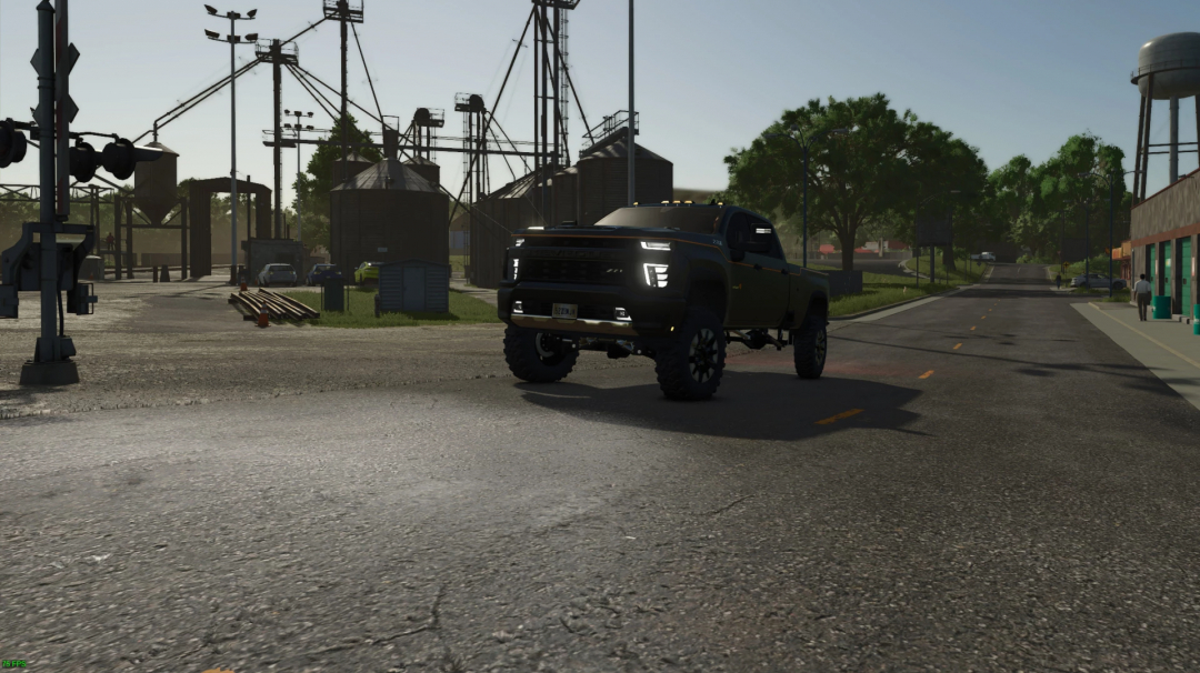 Carhartt Silverado V1.0.0.0 mod in FS25, showcasing a lifted truck on a farm road with silos visible in the background.