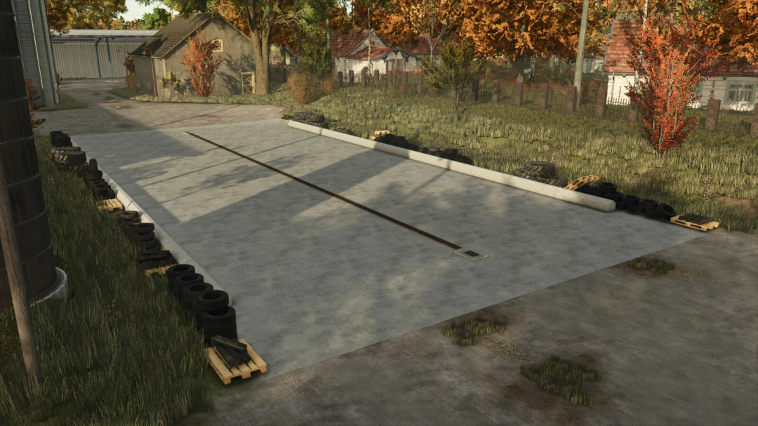 Concrete Free Land Silo Pack mod for FS25, featuring a concrete area surrounded by tires in a rural setting.