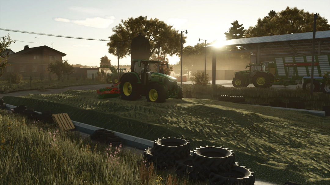 FS25 mods Concrete Free Land Silo Pack v1.0.0.0 showing tractors at sunset on a farm