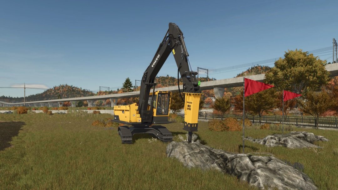 Excavator Tool Pack in FS25 mod, breaking rocks in a grassy landscape with red flags and a bridge in the background.