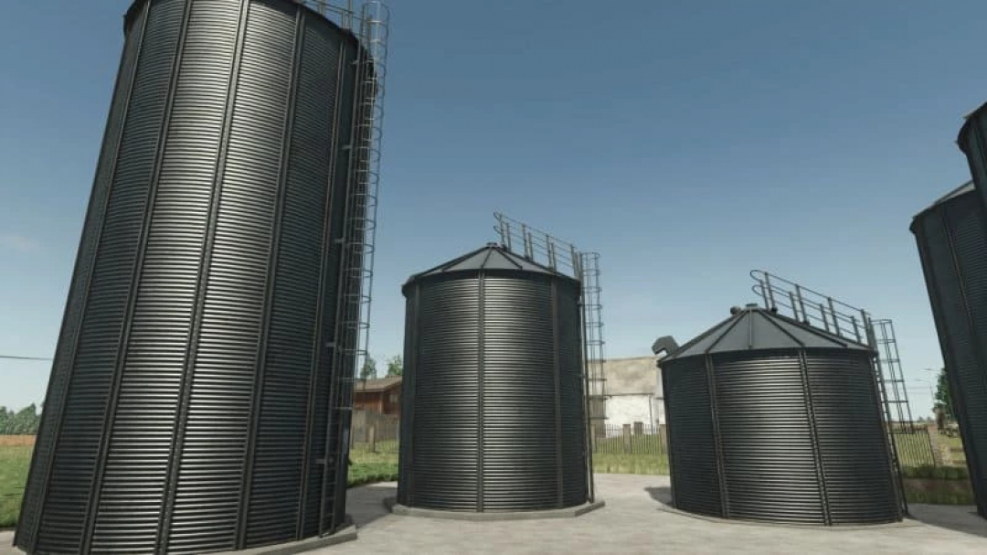 Old silo bins mod for FS25 with black metal structures under blue sky.