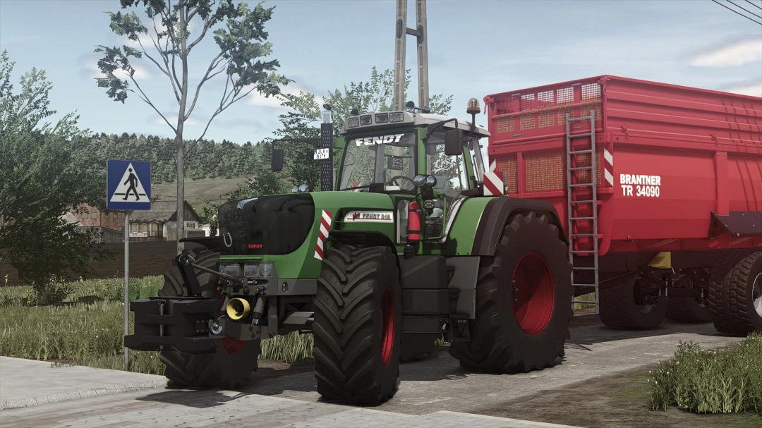 Fendt 900 TMS Vario G2 mod in FS25 with Brantner trailer on a rural road.