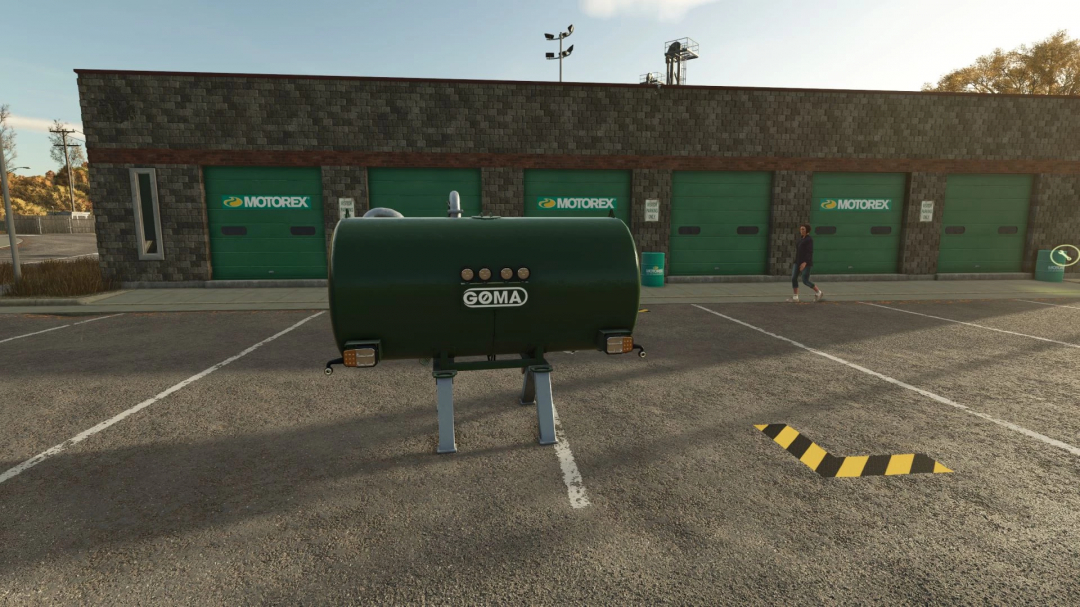 Goma Tank mod for FS25 displayed in front of a Motorex garage in Farming Simulator 25.