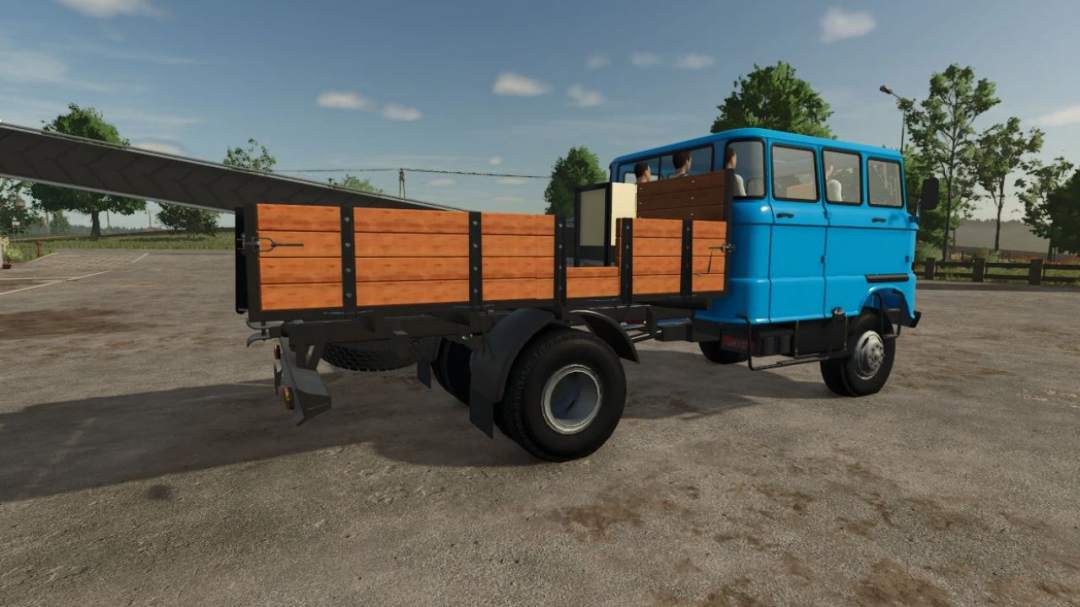 FS25 mods: IFA W50 Harvester Brigade v1.0.0.0, featuring a classic blue truck with a wooden bed for Farming Simulator 25.