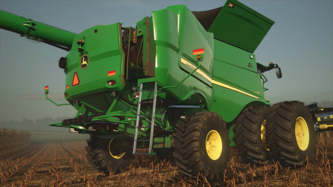 John Deere S700 Series harvester mod in FS25, showcasing its robust design and large wheels on a farming field.