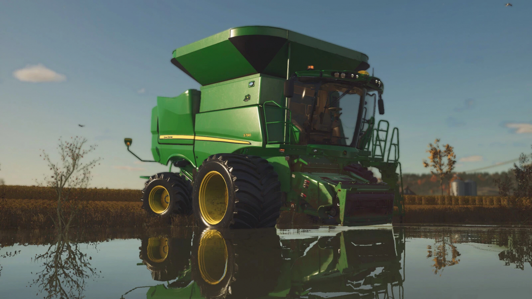 John Deere S700 Series combine in FS25 mod, reflecting in water on a farm field.