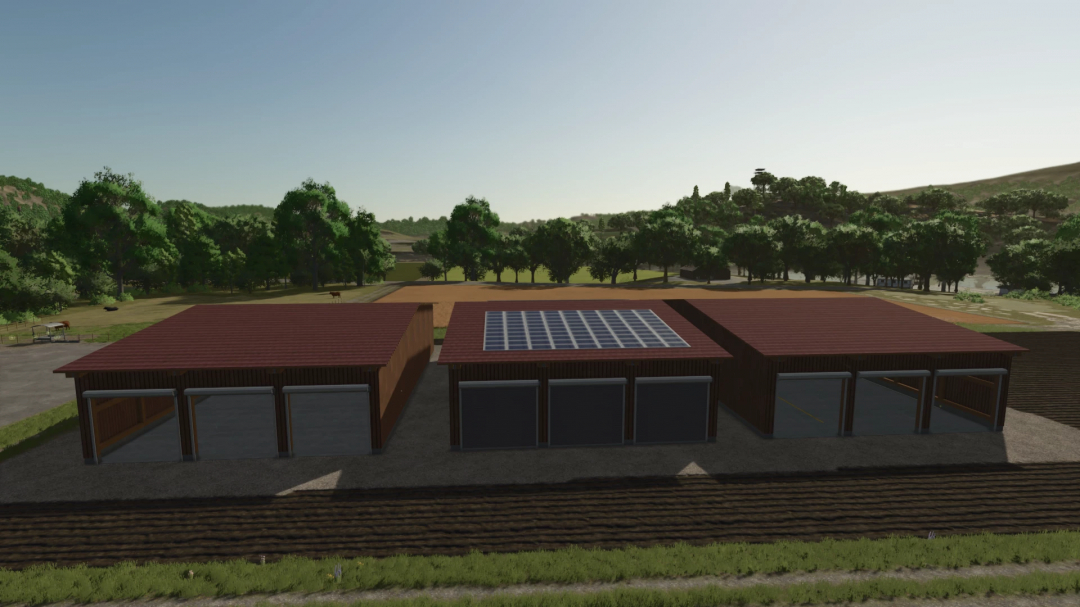 LSFM Drive Through Hall Pack in FS25 game, showcasing garages with solar panels amidst a lush landscape.