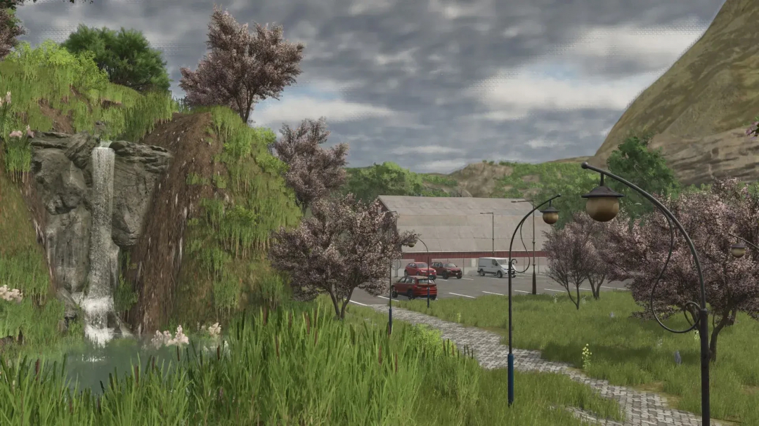 Scenic view of LoneHills Map in FS25 mod, featuring a waterfall, trees, and a parking area under cloudy skies.