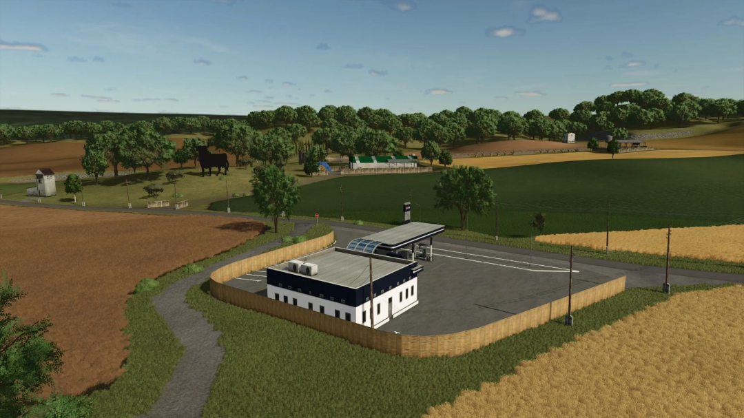 Aerial view of Los Corrales 2K25 mod for Farming Simulator 25, featuring a rural landscape with a gas station and fields.