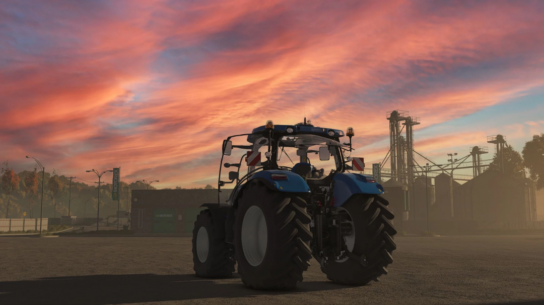 New Holland T7 Series tractor mod for Farming Simulator 25 at sunset with silos in background. FS25 mods enhance gameplay.