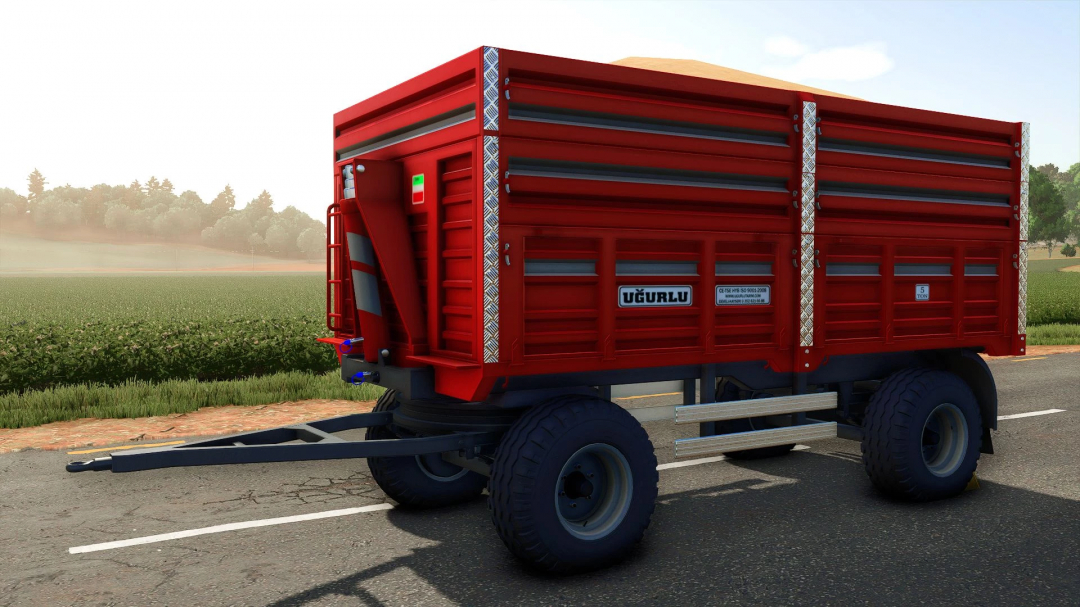 Ugurlu Agricultural Trailer 5T mod in FS25, showcasing a red trailer against a lush farm backdrop.