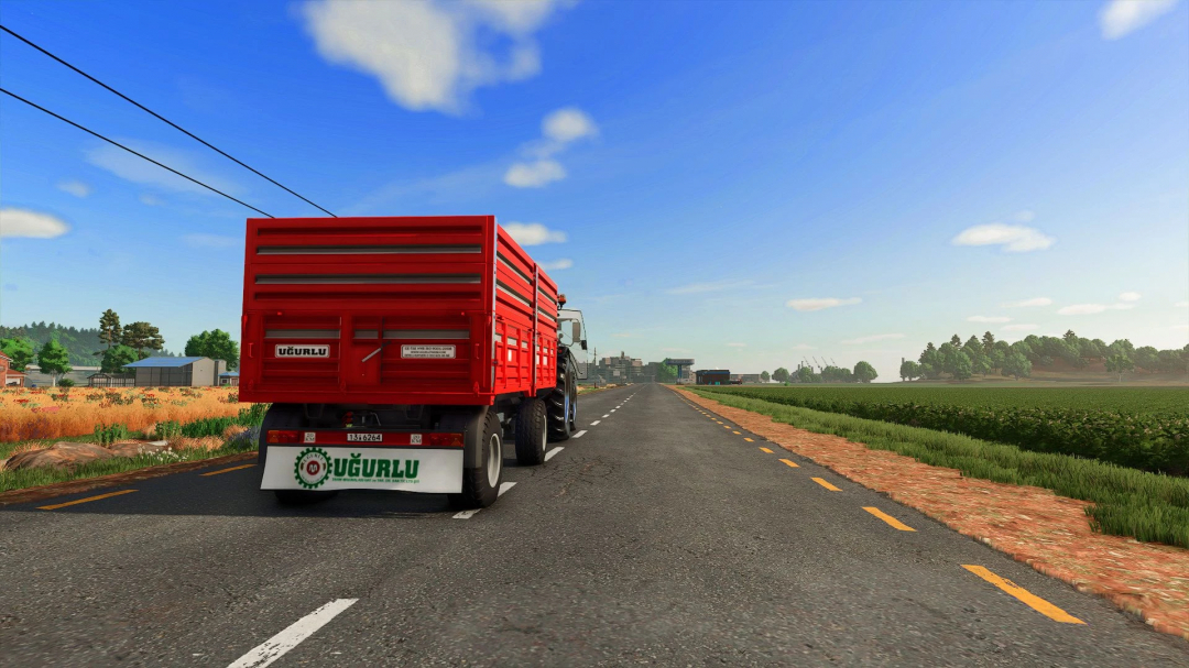 FS25 mod Ugurlu Agricultural Trailer 5T v1.0.0.0 on a road with fields and trees.