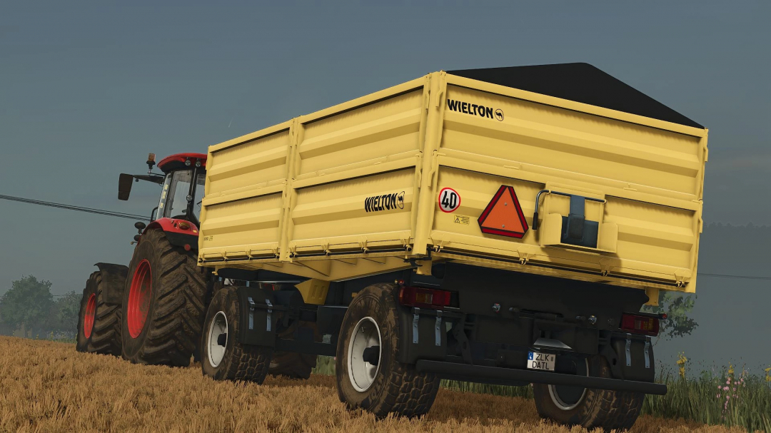 Yellow Wielton trailer attached to red tractor in a field, FS25 mods, Farming Simulator 25.