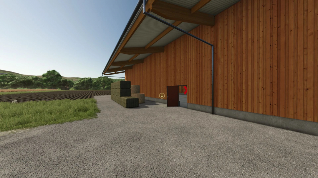 Wooden Bale Storage Shed in FS25 mod, surrounded by fields with stacked hay bales outside.